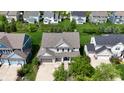 A view of several homes featuring manicured lawns, driveways, and well-maintained exteriors at 12722 Moonseed Dr, Carmel, IN 46032