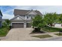 The home has an attached two-car garage and neutral-colored siding at 12722 Moonseed Dr, Carmel, IN 46032