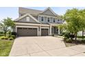 Traditional two-story home featuring a three-car garage and mature landscaping for enhanced curb appeal at 12722 Moonseed Dr, Carmel, IN 46032