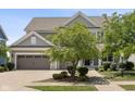 Traditional two-story home featuring a three-car garage and mature landscaping for enhanced curb appeal at 12722 Moonseed Dr, Carmel, IN 46032
