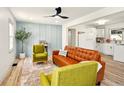 Bright living room with light blue accent wall, modern fan, and open layout to the kitchen at 1337 N Concord St, Indianapolis, IN 46222