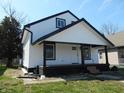 Two-story home featuring white siding, a covered porch, and black accent trim at 1545 Finley Ave, Indianapolis, IN 46203