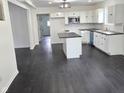 Modern kitchen with white cabinets, stainless steel appliances, and a kitchen island at 1545 Finley Ave, Indianapolis, IN 46203