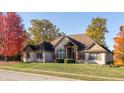 Beautiful single Gathering home featuring a stone and brick facade and colorful trees at 1832 Live Oak Ct, Avon, IN 46123