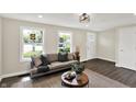 Bright and inviting living room with large windows, modern flooring, and comfortable seating at 1944 Galeston Ct, Indianapolis, IN 46229