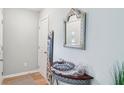 Bright foyer with neutral walls, decorative mirror, and sleek table display at 217 Devonshire Ct, Anderson, IN 46013