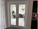 View through double doors to an office with home gym and neutral decor at 230 Kiawah Dr, Whiteland, IN 46184