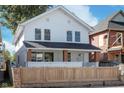 Charming two-story home with a well-maintained front yard and a classic white exterior at 2442 Guilford Ave, Indianapolis, IN 46205