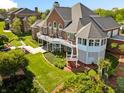 A stunning outdoor space featuring a large deck, manicured landscaping and lush lawns at 3107 Waterfront Cir, Anderson, IN 46012