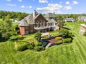 Sprawling estate featuring a manicured lawn, tiered garden, and outdoor fountain at 3107 Waterfront Cir, Anderson, IN 46012