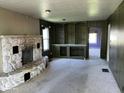 Spacious living room with a stone fireplace and built-in shelving at 3209 Mounds Rd, Anderson, IN 46016