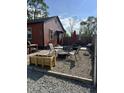 A backyard seating area with a fire pit on a rock garden with chairs and grill for outdoor enjoyment at 3302 N Gladstone Ave, Indianapolis, IN 46218