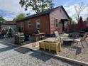 Backyard patio and sitting area with a fire pit, perfect for outdoor entertaining and summer evenings at 3302 N Gladstone Ave, Indianapolis, IN 46218