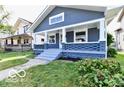 Attractive home with a covered front porch and updated exterior design at 36 N Ewing St, Indianapolis, IN 46201