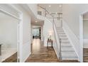 Spacious foyer with hardwood floors, a staircase, and an abundance of natural light at 3743 Earhart Dr, Carmel, IN 46074