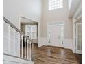 Spacious foyer with hardwood floors, a staircase, and an abundance of natural light at 3743 Earhart Dr, Carmel, IN 46074