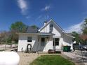 Rear exterior view of home with white siding, showcasing a small backyard and landscaping at 4200 Ann St, Plainfield, IN 46168