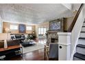 Spacious living room with stone fireplace and stairs, filled with natural light at 4244 Rookwood Ave, Indianapolis, IN 46208