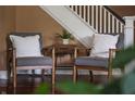 Cozy sitting area with two chairs near the staircase and beautiful hardwood floors at 4244 Rookwood Ave, Indianapolis, IN 46208
