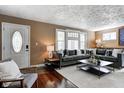 Inviting living room featuring a comfortable gray sectional sofa and ample natural light at 4244 Rookwood Ave, Indianapolis, IN 46208