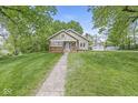 Beautifully landscaped yard with a charming home, long driveway, and garage at 440 W Marion St, Danville, IN 46122