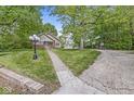 Exterior view of home, driveway, and garage with mature trees at 440 W Marion St, Danville, IN 46122