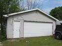 Spacious detached garage with a large white door and a convenient side entrance at 470 N Pine St, Morgantown, IN 46160
