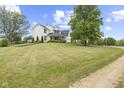 Beautiful two-story home showcasing a spacious green lawn, and mature trees at 4749 Maple Grove Rd, Martinsville, IN 46151