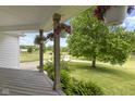 Inviting front porch adorned with hanging flower baskets at 4749 Maple Grove Rd, Martinsville, IN 46151