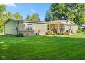 Single-story home with a covered front porch, showcasing its charming curb appeal and lawn at 48 W Adams Brick Ave, Martinsville, IN 46151