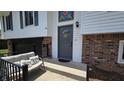 Welcoming front entrance features a gray front door, brick accent wall, and a cozy bench at 492 Pelenor Dr, Franklin, IN 46131
