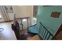 Hallway with wooden stairs leading to a door and a wall with decor at 492 Pelenor Dr, Franklin, IN 46131