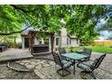 Relaxing backyard with deck, hot tub, brick patio, and mature trees that offer plenty of shade at 497 Pebble Way, Greenwood, IN 46142