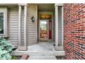 Inviting front porch with decorative door and sidelights flanked by brick and wooden siding at 497 Pebble Way, Greenwood, IN 46142