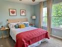 Bright bedroom with a double bed, pastel walls, natural light, and framed artwork on the walls at 523 Torrey Ct, Avon, IN 46123