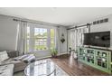 Bright living room with large windows, hardwood floors, and stylish decor at 523 Torrey Ct, Avon, IN 46123