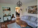 Cozy living room with hardwood floors, comfortable seating, and decorative artwork at 6006 Buell Ln, Indianapolis, IN 46254