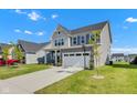 Beautiful two-story home with manicured lawn, a two car garage, and a long driveway at 6305 Norwich Dr, Brownsburg, IN 46112