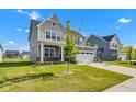 Beautiful two-story home with manicured lawn, a two car garage, and modern gray and white color scheme at 6305 Norwich Dr, Brownsburg, IN 46112