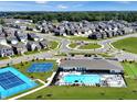 Stunning aerial view of the community featuring a pool, tennis court, and well-manicured landscaping at 6429 Yuma Ct, Whitestown, IN 46075