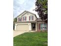 Charming two-story home with red shutters, attached garage, and well-maintained lawn and garden at 6550 Spring Flower Dr, Indianapolis, IN 46237