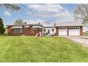 Backyard featuring a brick home, two car garage, and playset at 6585 N Waverly Park Rd, Martinsville, IN 46151