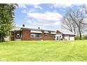 Brick home exterior featuring a grassy lawn and a detached garage at 6585 N Waverly Park Rd, Martinsville, IN 46151