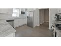 Modern kitchen features stainless steel appliances, white cabinets, and light hardwood floors at 701 Lincoln St, Indianapolis, IN 46203