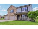 Charming two-story home featuring a brick facade, light gray siding, and a welcoming front porch at 7157 Chemistry Ct, Indianapolis, IN 46239