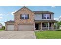 Lovely two-story home showcasing a brick facade, light gray siding, and a covered porch at 7157 Chemistry Ct, Indianapolis, IN 46239