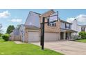 This charming home boasts a basketball hoop over a spacious driveway and an attached two-car garage at 7157 Chemistry Ct, Indianapolis, IN 46239
