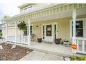 Inviting front porch with decorative hanging plants, seating, and a welcoming entrance at 7249 Tappan Dr, Indianapolis, IN 46268