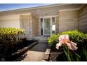 Beautiful front entrance with stone facade, flower bed, and a charming covered porch at 7285 E County Road 900 N, Brownsburg, IN 46112