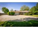 Ranch home with beautiful landscaping, a long driveway, and a basketball hoop near the garage at 7285 E County Road 900 N, Brownsburg, IN 46112